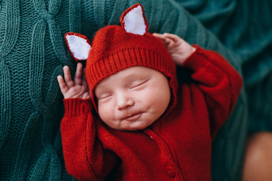 sleeping baby in red suit